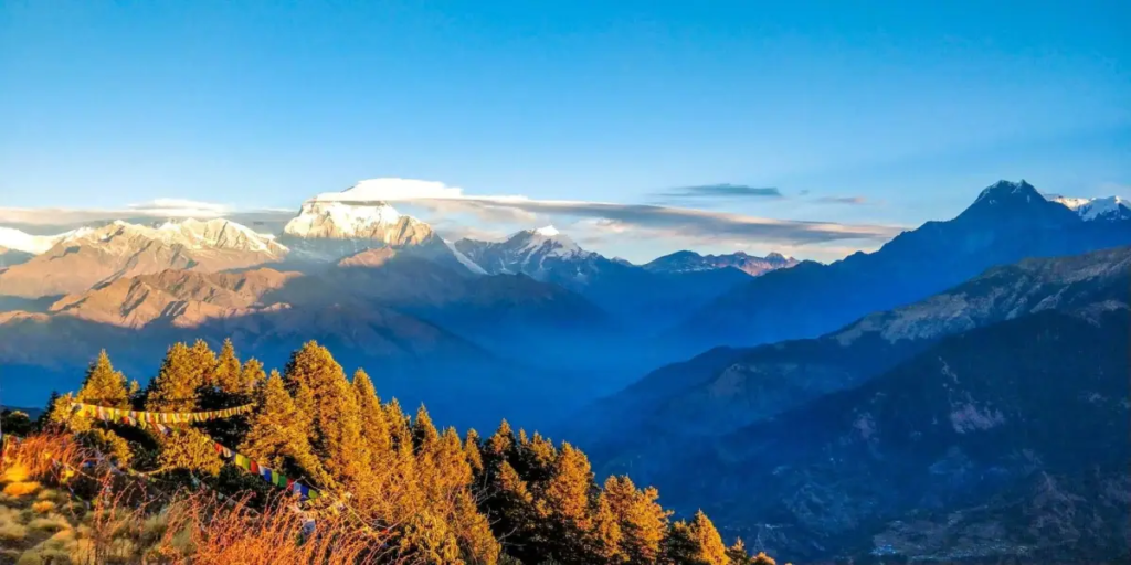 A breathtaking view showcasing the Most Beautiful Adventure Destinations surrounded by stunning natural landscapes. Towering snow-covered mountains rise above crystal-clear lakes, while lush green forests stretch across peaceful valleys. A winding hiking trail leads through colorful wildflowers toward dramatic cliffs and cascading waterfalls under a bright blue sky. Adventurers explore the untouched wilderness, enjoying activities like trekking, camping, kayaking, and wildlife watching. Fresh mountain air, golden sunlight, and the beauty of nature create an unforgettable outdoor experience. This scenic destination perfectly captures the spirit of adventure travel, inspiring explorers to discover breathtaking landscapes, hidden trails, and remarkable natural wonders around the world. It is an ideal representation of the Most Beautiful Adventure Destinations for nature lovers and thrill seekers alike.