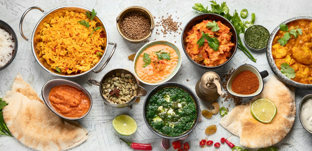 A colorful table filled with healthy recipes for every day, featuring a bowl of fresh oatmeal topped with berries, grilled chicken with brown rice and steamed vegetables, a vibrant mixed salad with leafy greens, avocado, tomatoes, and cucumbers, plus a nutritious vegetable soup garnished with fresh herbs. The scene highlights wholesome ingredients including seasonal fruits, whole grains, lean proteins, nuts, and seeds arranged in natural daylight. This healthy meal spread represents simple, nutritious, and tasty everyday recipes that support a balanced lifestyle, healthy eating habits, and homemade cooking using fresh ingredients inspired by nature. Perfect for anyone looking to enjoy delicious meals that promote wellness, energy, and long-term health while making everyday cooking easy and enjoyable.